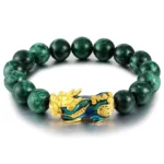 Cyan jade Pi Xiu protection bracelet with dark green round beads and gold enamel charm on white background