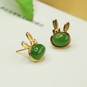 Sterling silver rabbit jade earrings side view, showing detailed ear posts and smooth cyan jade stone luster