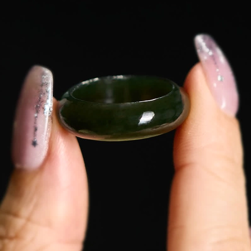 Cyan jade band ring close-up front shot with manicured fingers on dark background, demonstrates ring size and glossy finish