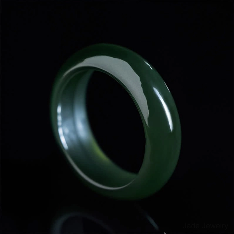 Cyan jade healing ring overhead view against pure black background, round shape with high gloss polish