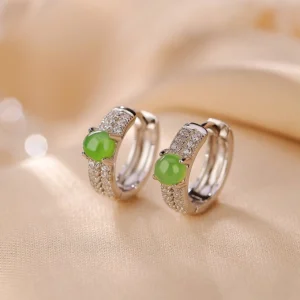 Cyan jade and sterling silver hoop earrings side view with soft bokeh background