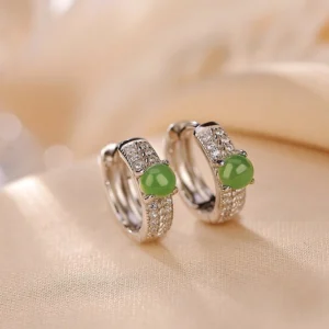 925 sterling silver cyan jade stud earrings front view overhead on beige silk fabric