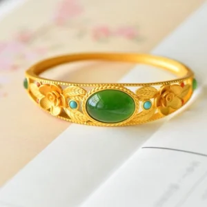 Cyan jade and white jade flower bangle with floral filigree and oval center stone, premium metal setting, top-down view