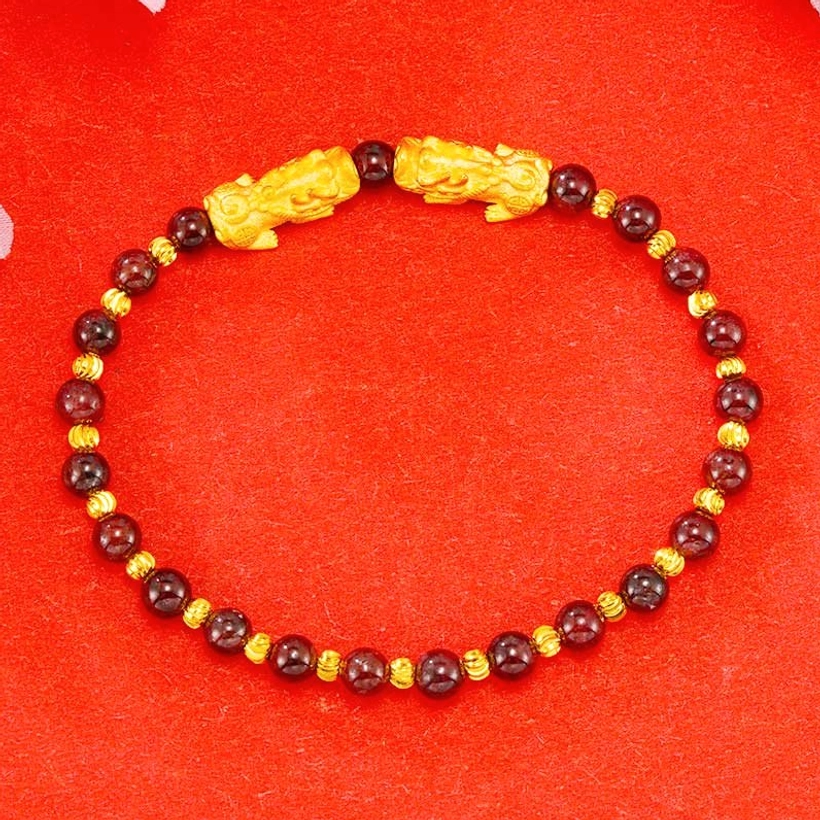 Gold-plated double Pixiu dark red wine agate wealth bracelet flat lay, premium natural gemstone beads with metallic accents