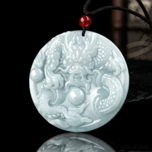 Embossed dragon playing pearl design on round celadon jade pendant necklace - detailed carving with dark background