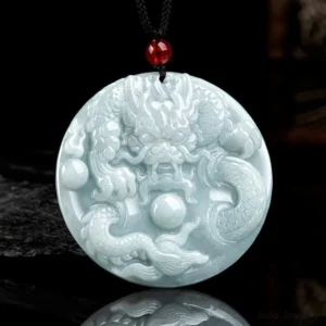 Dragon jade pendant necklace front view - embossed dragon design on light celadon jade with black cord and red bead accent