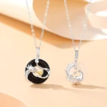 Dragon and Phoenix couple peace buckle necklaces in 925 sterling silver with black onyx and white chalcedony on warm minimalist background, showing matching pair set for couples