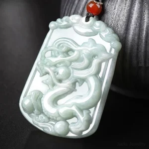 Dragon zodiac jade pendant necklace with hand-carved relief, natural light green jade stone with red auspicious bead and brown hemp cord, celestial talisman