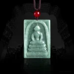 Formless Buddha jade square pendant hanging necklace with red bead and brown cord on dark background