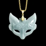 Intricately carved fox mask jade pendant with floral details, featuring light cyan natural jade on polished titanium steel chain