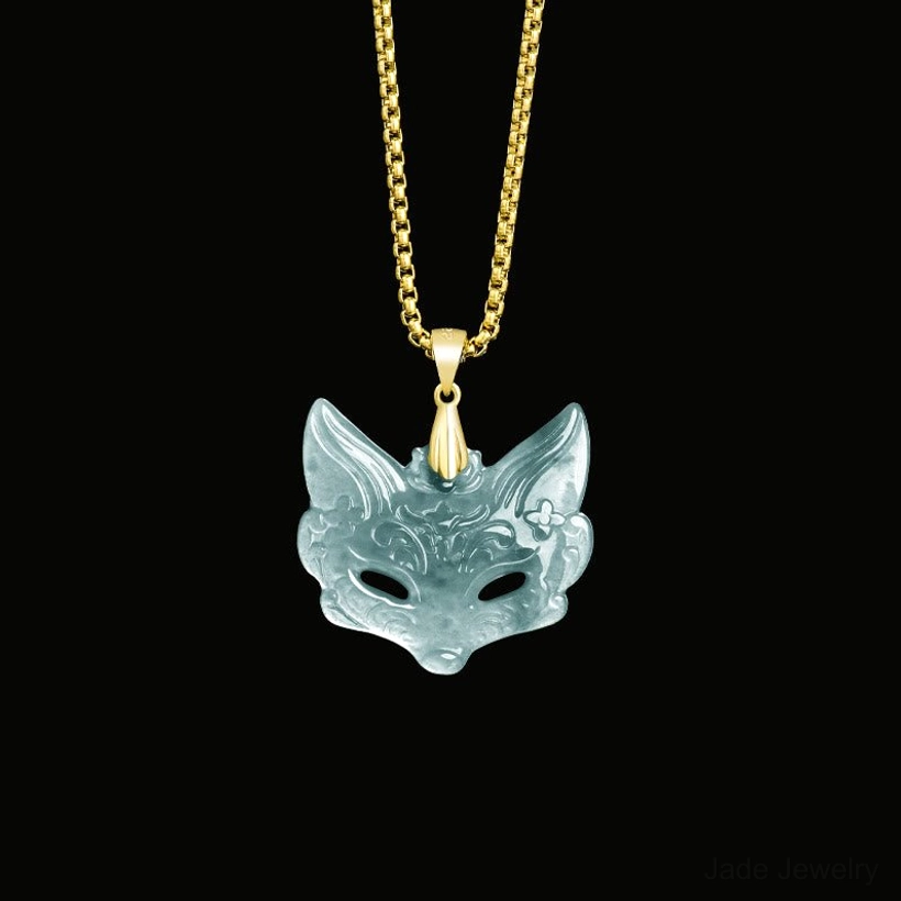 Minimalist fox mask jade pendant with simple carved design on thin polished titanium steel chain, studio overhead shot