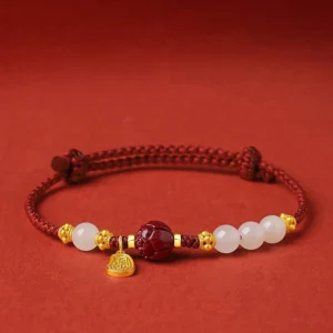 Fu character jade cinnabar red string bracelet with 24K gold plated pendant flat lay front view