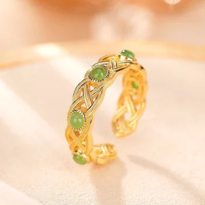 Gold-plated braided jade ring with Celtic woven texture and inlaid green jade stones - close-up detail