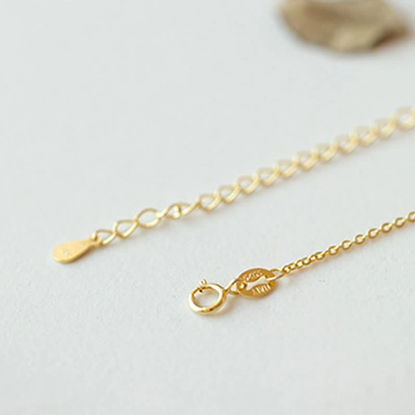 Top-down flat lay of 925 sterling silver gold-plated necklace chain showing polished finish, adjustable extension chain, and spring ring clasp