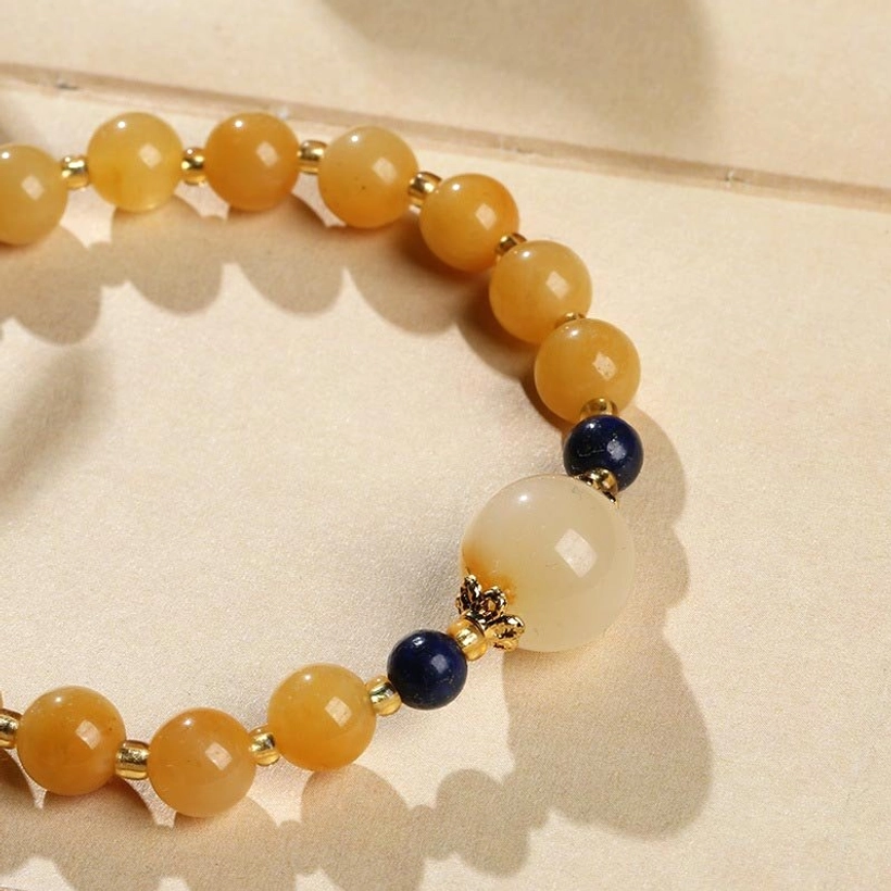 Golden Silk Jade Beads and Blue Spacer Detail - Texture and Craftsmanship