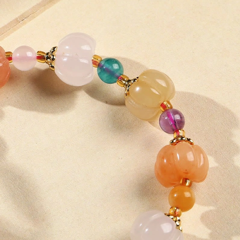 Side view golden silk jade pixiu bracelet showing pumpkin beads and mixed color stone details