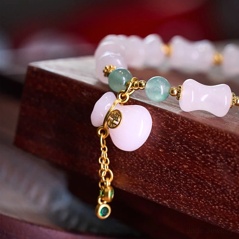 Lucky jade bracelet with fortune bag pendant and Fu character tag showing green aventurine stones and gold accents