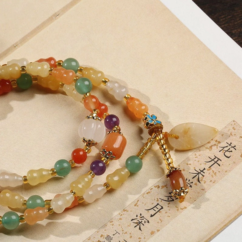 Golden Silk Jade Gourd Bracelet - Partial close-up showing leaf pendant, clasp hardware, and mixed-tone gemstone strands