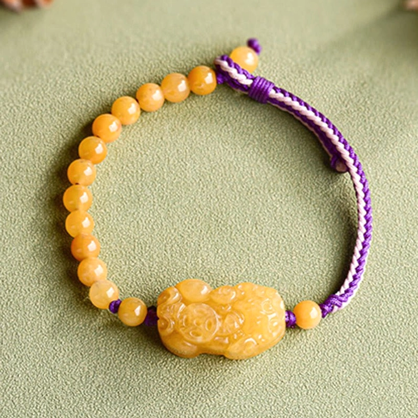 Golden Silk Jade Pi Xiu prosperity bracelet overhead full circle view showing yellow jade beads and central wealth charm