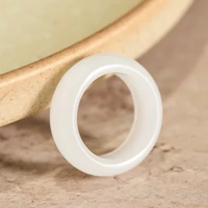 Golden silk jade wealth ring three-quarter close-up view showing smooth polished band and natural jade luster