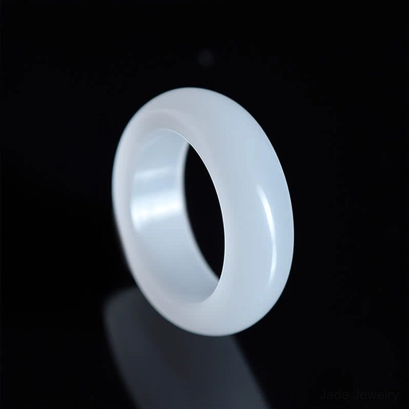 Pale translucent golden silk jade ring side profile showing light-colored rounded band and natural jade texture