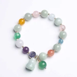 Gourd jade bracelet with pastel pink crystal and citrine beads, top-down flat lay view showing complete design
