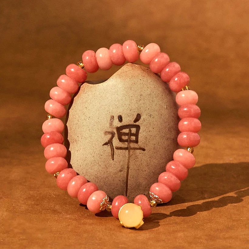 Gradient Pink Healing Bracelet with Warm Tone Accent Beads - Zen Stone Background Flat Lay