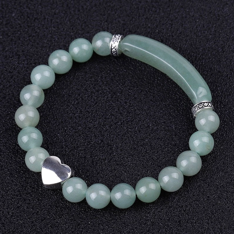 Green aventurine crystal bracelet oblique view showing curved stone detail and heart charm