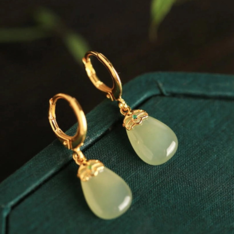 Green chalcedony jade earrings pair display showing matching water drop design symmetry natural stone variations authenticity