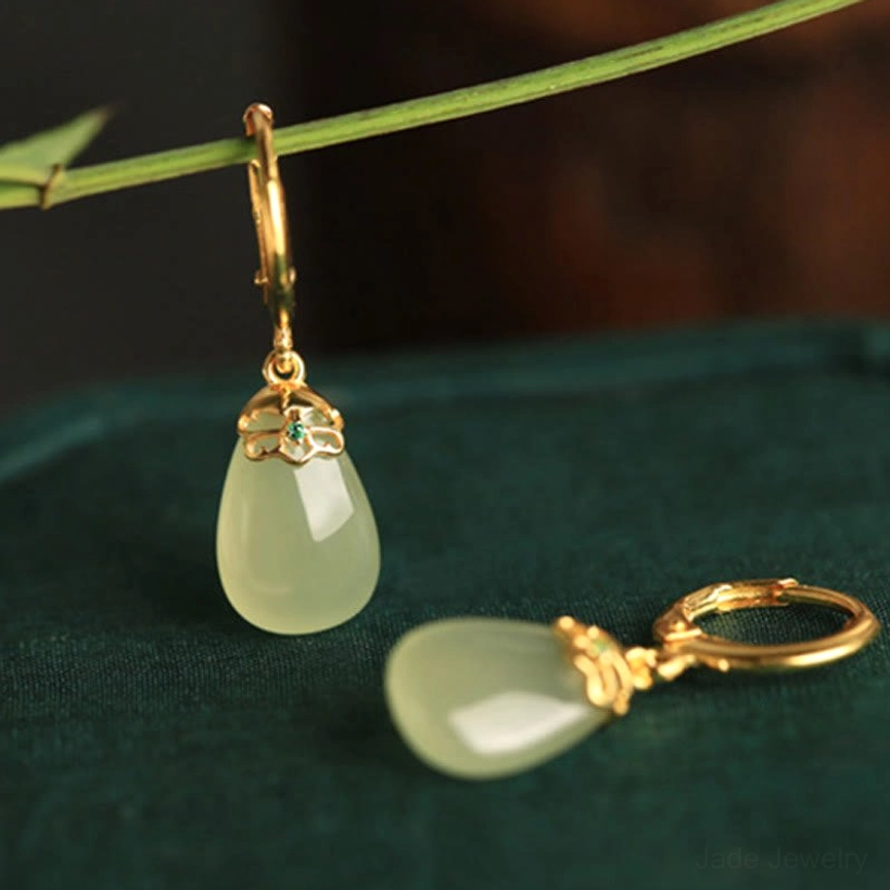 Green chalcedony jade earrings close-up showing pale green stone texture polished finish gold-toned copper hardware