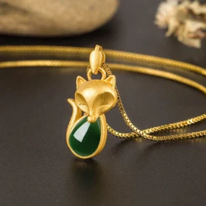 Gold fox pendant with green chalcedony stone - front facing close-up detail shot with box chain