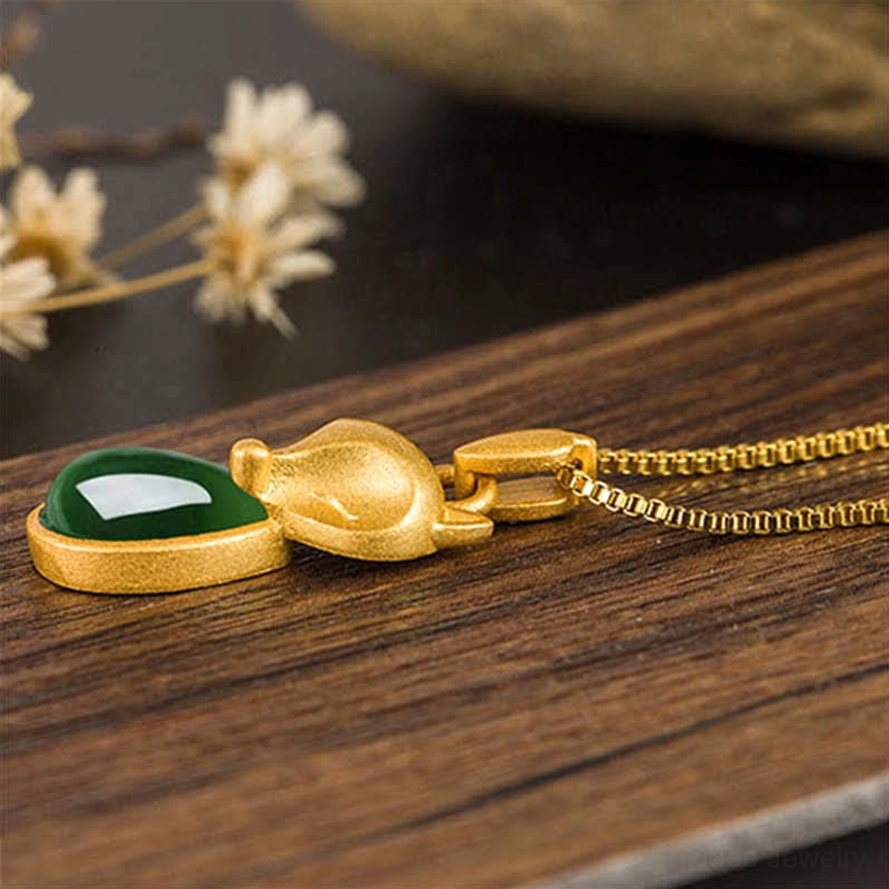 Fox jade gold pendant with chain - top-down flat lay on wood showing reverse side and necklace