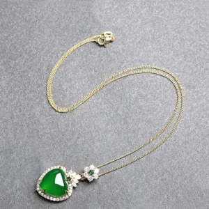 Full green chalcedony heart necklace with adjustable gold chain displayed flat lay