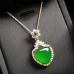 Green chalcedony heart pendant necklace close-up detail with gold-toned setting and cubic zirconia accents