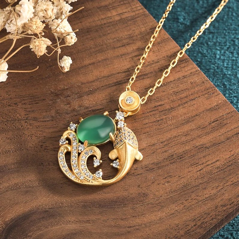 Side profile green chalcedony koi fish pendant showing intricate zircon-inlaid wave ornament details