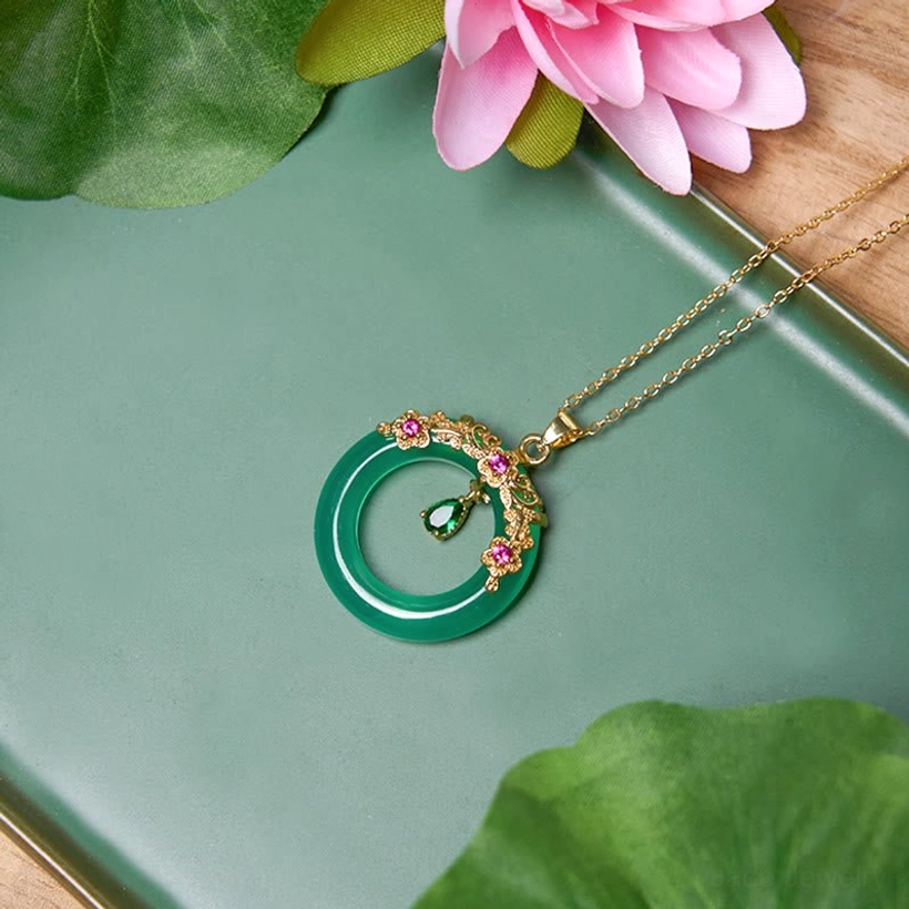 Green chalcedony peace buckle pendant with lotus flower background and dark green styling