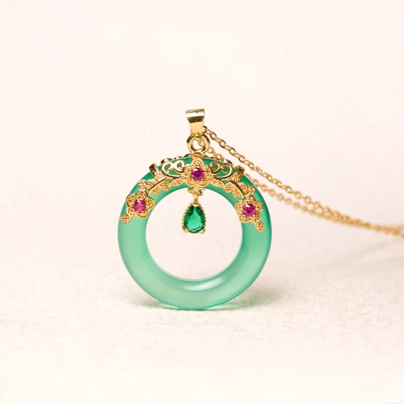 Green chalcedony peace buckle necklace with thin gold chain on light beige background