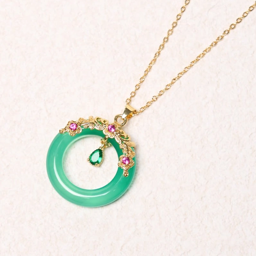 Single green chalcedony peace buckle pendant necklace with gold ornate setting close-up