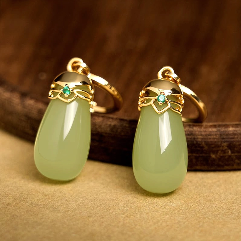 Green chalcedony water drop earrings on dark wood background with light green jade drop gold hardware and tiny green zircon accent details