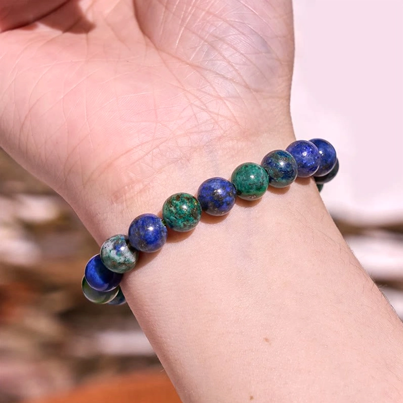 Green harmony jade crystal bracelet, close-up detail view showing individual polished beads and elastic string construction
