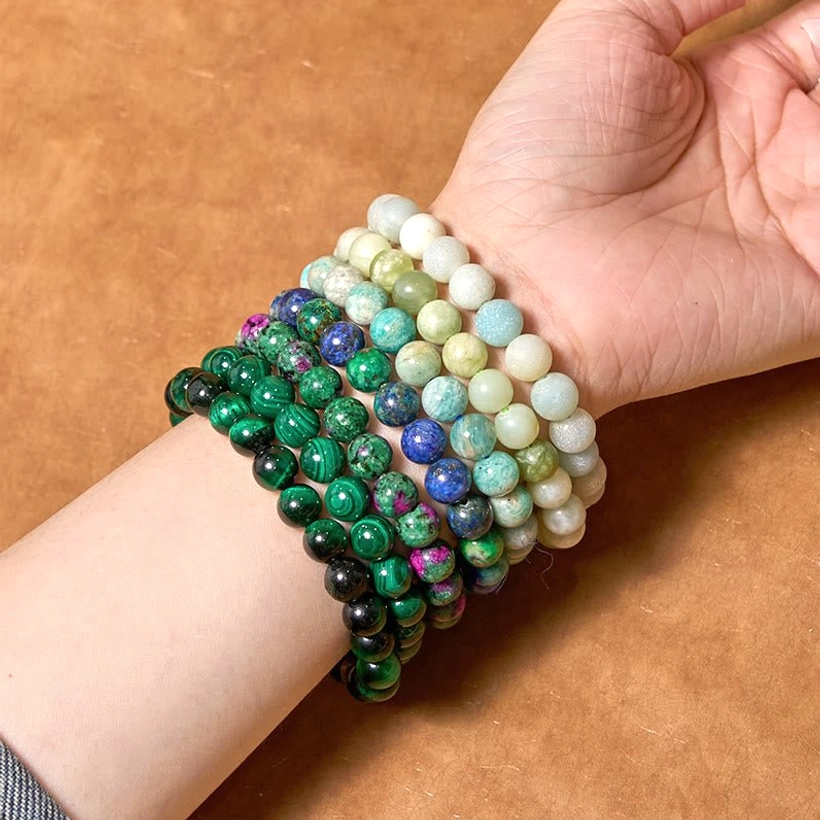 Two jade amazonite balance bracelets displayed on arms, overhead view showing dark green ruby zoisite and light neutral amazonite variations