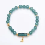 Natural green jade bamboo bracelet with gold-plated silver spacers displayed on white background, showcasing full beaded chain and ornamental bamboo charm