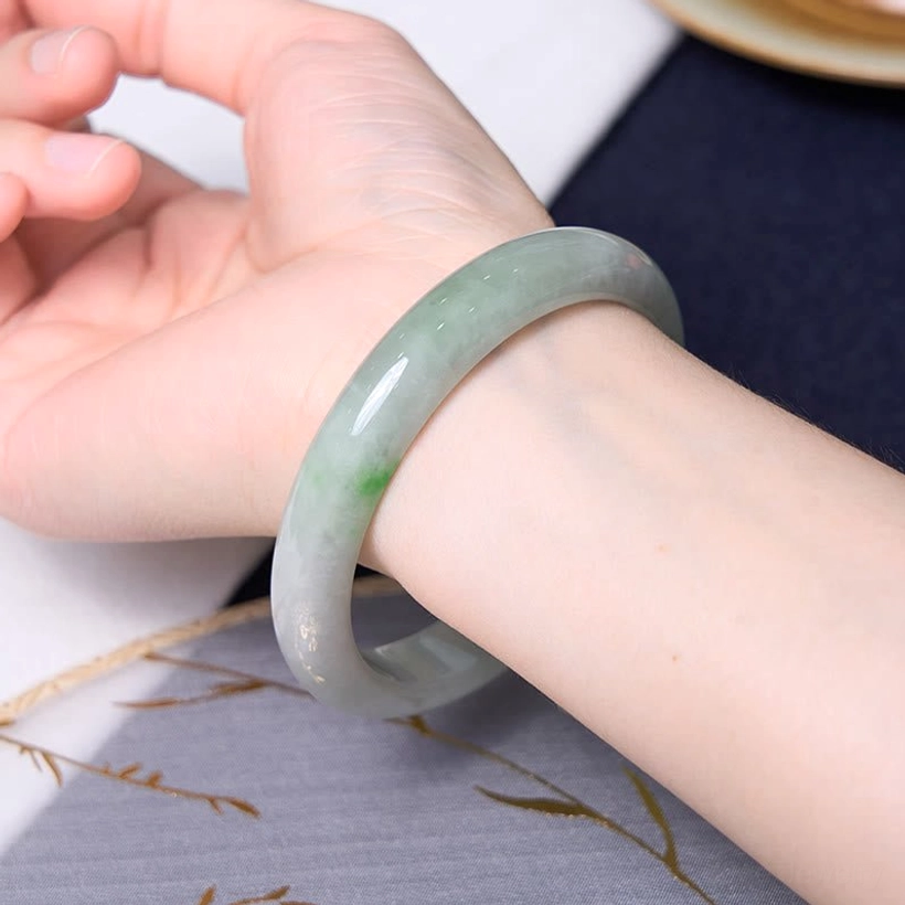 Jade beaded bracelet worn on wrist with prosperity symbols and decorative elements