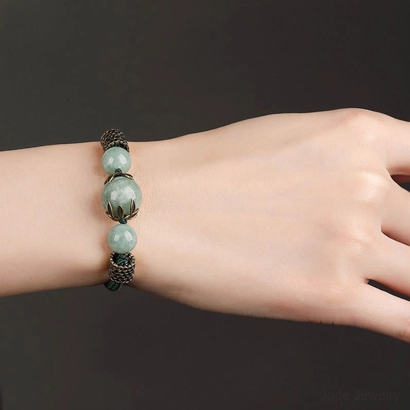 Minimalist presentation of green jade prosperity bracelet with neat arrangement of metal and jade beads
