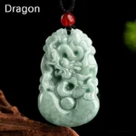 Natural green jade Dragon zodiac pendant necklace with carved dragon relief and red bead on black cord, displayed on wooden prop with studio lighting