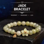 Green jade prosperity bracelet with Fu character charm - flat lay on dark starry display platform showing light green jade beads and gold flower accent