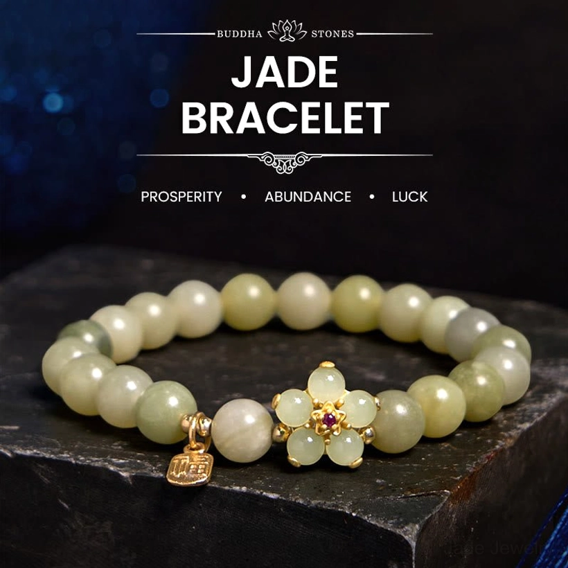 Green jade prosperity bracelet with Fu character charm - flat lay on dark starry display platform showing light green jade beads and gold flower accent