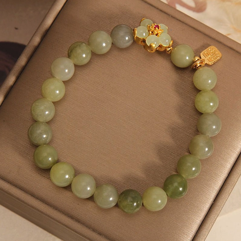 Green jade beaded bracelet with Fu character charm - lifestyle image showing natural wearability and elegant design aesthetic