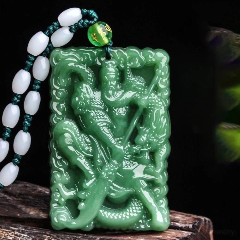 Green jade Lord Guan protection pendant necklace with hand-carved Guangong and dragon motif, paired with white jade and green bead mantra chain on wooden display