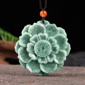Natural green jade lotus flower pendant with intricate multi-layer carved petals and detailed floral design, front view on dark background